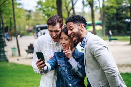 Multi-ethnic Group Of Friends Having Fun In Park Near Eiffelの写真素材