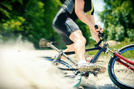 Young Man Riding His Mountain Bikeの写真素材