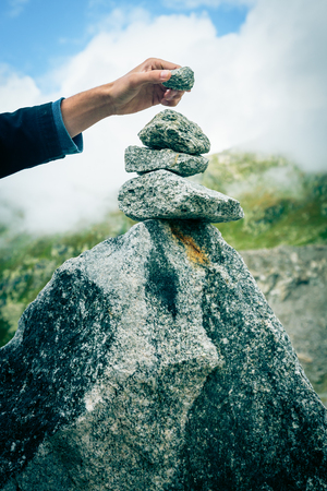 Young Man Building A Cairnの写真素材