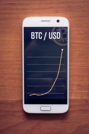 Bitcoin Cryptocurrency Financial Chart On Phoneの写真素材