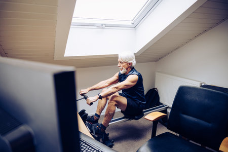 Senior Man Working Out in Home Officeの写真素材