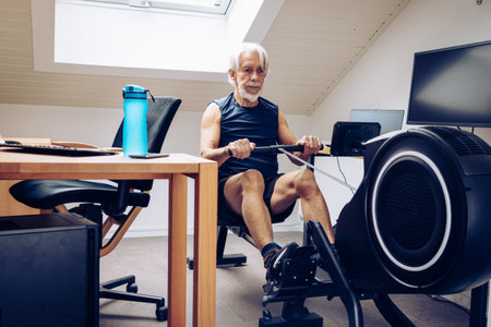 Senior Man Working Out in Home Officeの写真素材