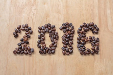 Seed coffee sort to numeral 2016 on wooden table ,の写真素材