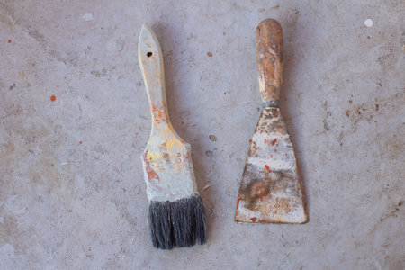 Old paint brush on cement backgroundの写真素材
