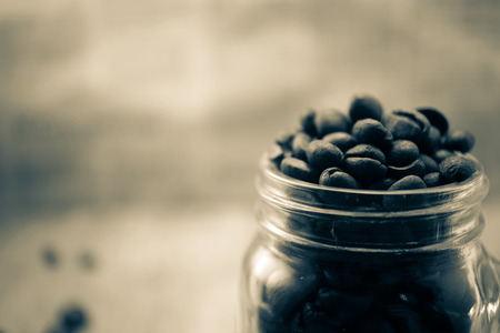 coffee with coffee beans and blur newspaper backgroundの写真素材