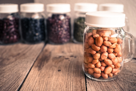 beans in the glass bottle on the old wood tableの写真素材