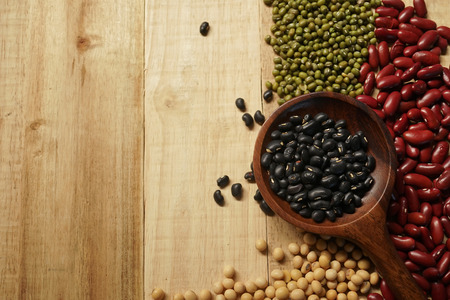 beans and a wooden spoon on the old wood tableの写真素材