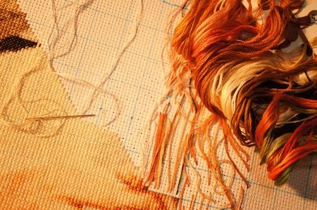 The process of cross stitch , working with the lamp