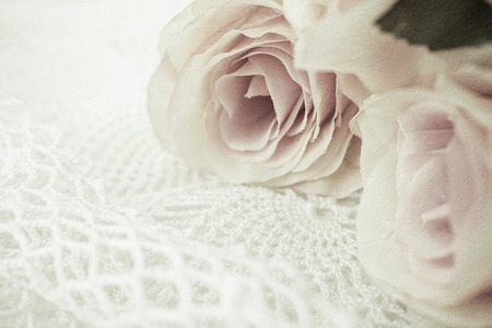 roses flowers in vintage color style on mulberry paper texture for romantic backgroundの写真素材
