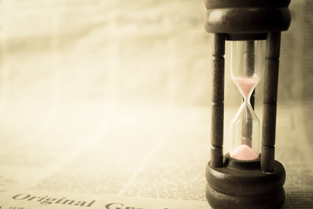 hourglass on newspaper in vintage styleの写真素材