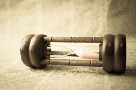 hourglass on newspaper in vintage styleの写真素材