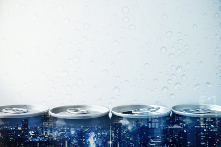 Double exposure of city and drink can on water drop backgroundの写真素材