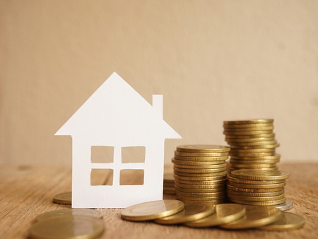 house model and row of coin money for finance and banking conceptの写真素材