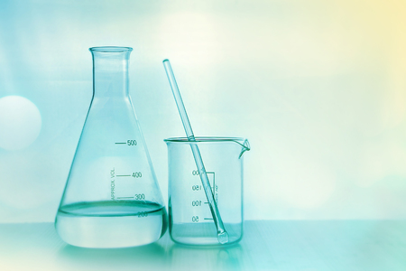 laboratory glasswares in soft color and blurred bokeh for science concept backgroundの写真素材