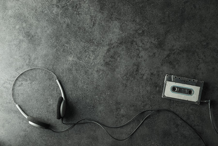 Earphone and Old cassette tape on dark background in vintage color styleの写真素材