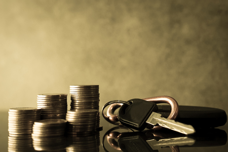 rows of coins on account and key of car for finance about car conceptの写真素材
