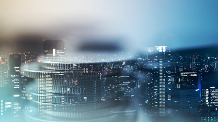 Double exposure of city and rows of coins for finance and banking conceptの写真素材