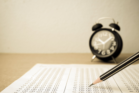 answer sheet , alarm clock and pencil for education conceptの写真素材
