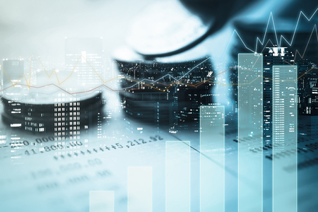 Double exposure of city, graph and rows of coins for finance and banking conceptの写真素材