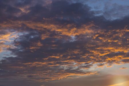 sky with black clouds and sun, backgroundの写真素材