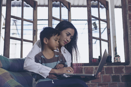 Little boy and his mother living notebook happily. Holiday their.の写真素材