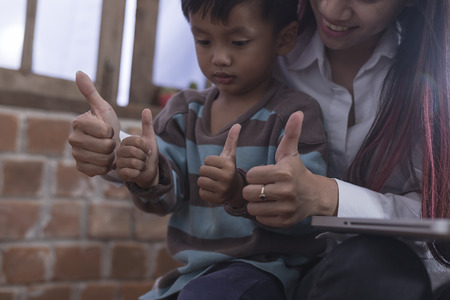 Little boy and his mother living notebook happily. Holiday their.
