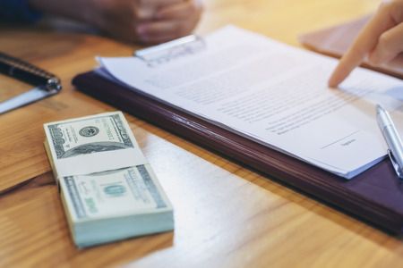 Businessman is signing a contract, business contract details, Signing and selling contractsの写真素材