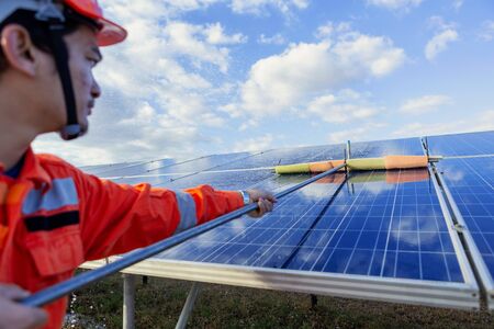 Engineers are checking the solar panel for maintenance. And clean the solar panel is always available.の写真素材