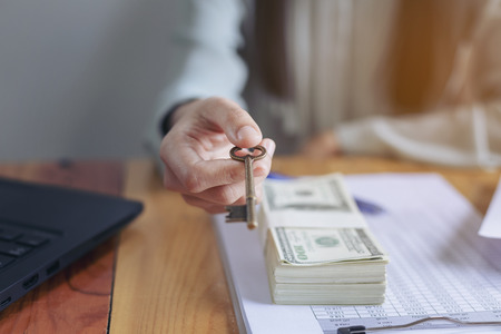 Successful business women are counting money and throwing a dollar at work happily.の写真素材