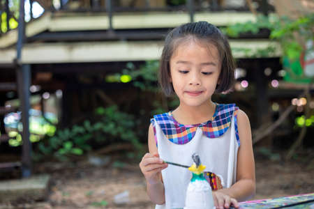 Cute little girl is learning outside the classroom happily with beautiful nature And a bright smileの写真素材