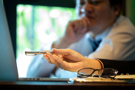 Businesses are offering alternative information to help decision makers in marketing planning. Diverse business team discuss statistical report infographics, charts shareの写真素材