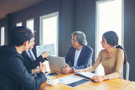 Serious business organizations gather to negotiate meetings led by older businessmen to discuss, offer solutions to current problems.の写真素材