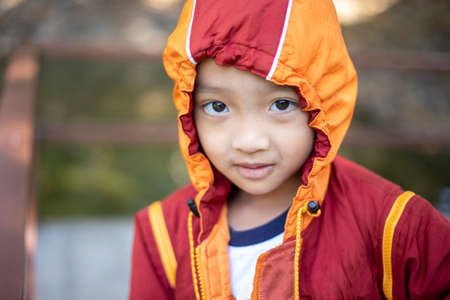 Asian woman wearing headphones using laptop sitting in her bedroom to communicate with friends during the epidemic of COVID-19の写真素材