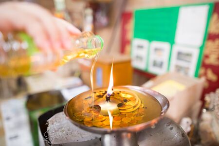 Pouring oil into the fireの写真素材