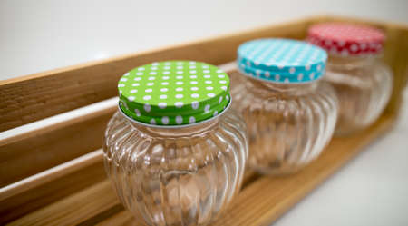 Place jars on a shelf made of wood.の写真素材