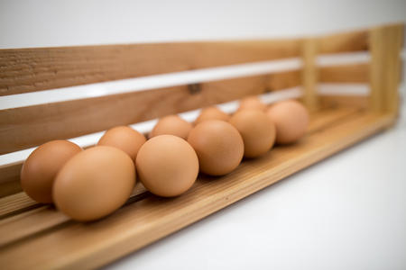 Eggs laid on wooden shelves.の写真素材