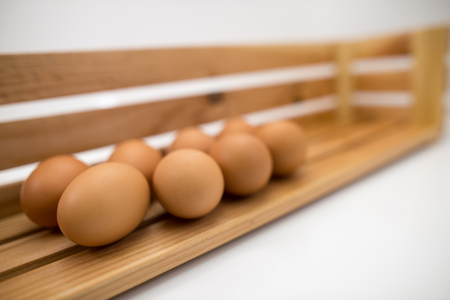 Eggs laid on wooden shelves.の写真素材