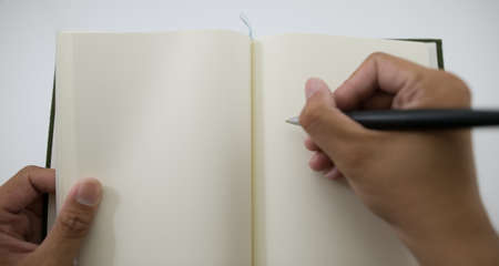 write something down on a notebook.の写真素材