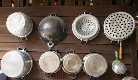 Utensils hanging on a wooden wallの写真素材