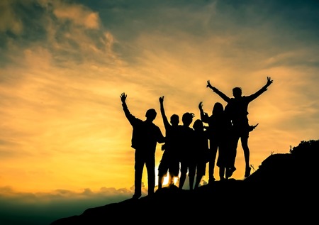 Silhouette people are happy on the slopes at sunsetの写真素材