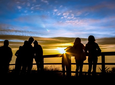 Silhouettes tourists are looking sunrise at view point on phutabberk mountain in north of thailand