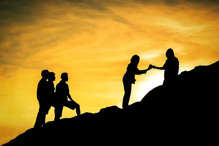 Silhouette people are getting something on the hillの写真素材