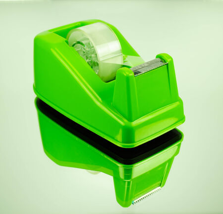Green tape Dispenser and Adhesive tape on glassの写真素材