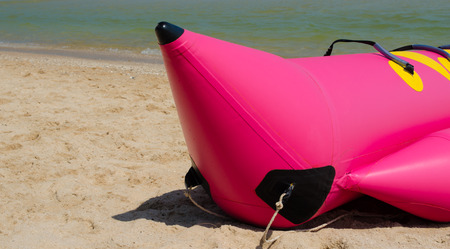 Pink banana boat on the beachの写真素材