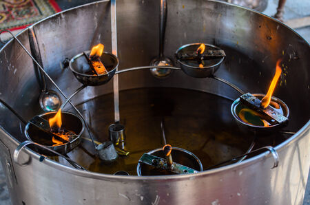 Temple oil lamp in Bandkhaeyai temple, Samudsongkham, Thailand.の写真素材