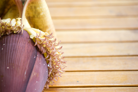 Banana blossoms on brown wood floor.の写真素材