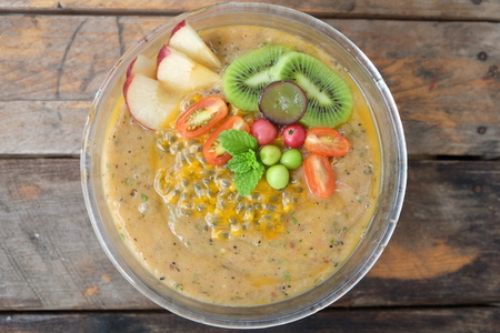Healthy Breakfast, Smoothie, Banana, Pineapple, Kiwi, Tomato, Apple, Gooseberry, Passion Fruit, Carrot, Grape, Jamaican Cherry and Mint with Black and White Sesame and Flaxseedの写真素材