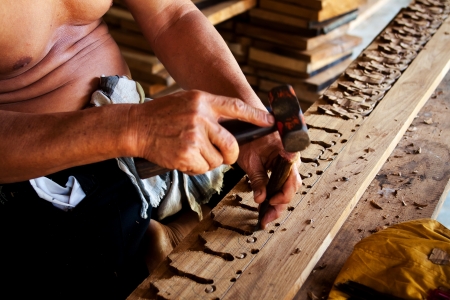 Sculptor is carving wood