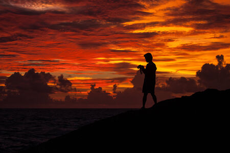 People stand amid the light fabric Tit sunset at the beach の写真素材