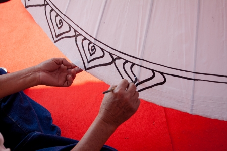 Coloring paints umbrella made of paper   fabric  Arts and crafts of the village Bo Sang, Chiang Mai Thailand の写真素材